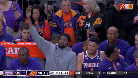 Kevin Durant pumps up the Phoenix Suns crowd for free chicken sandwiches.